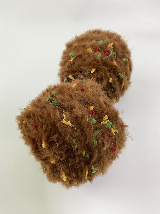 Ginger Cookie fancy yarn beside knitting needles