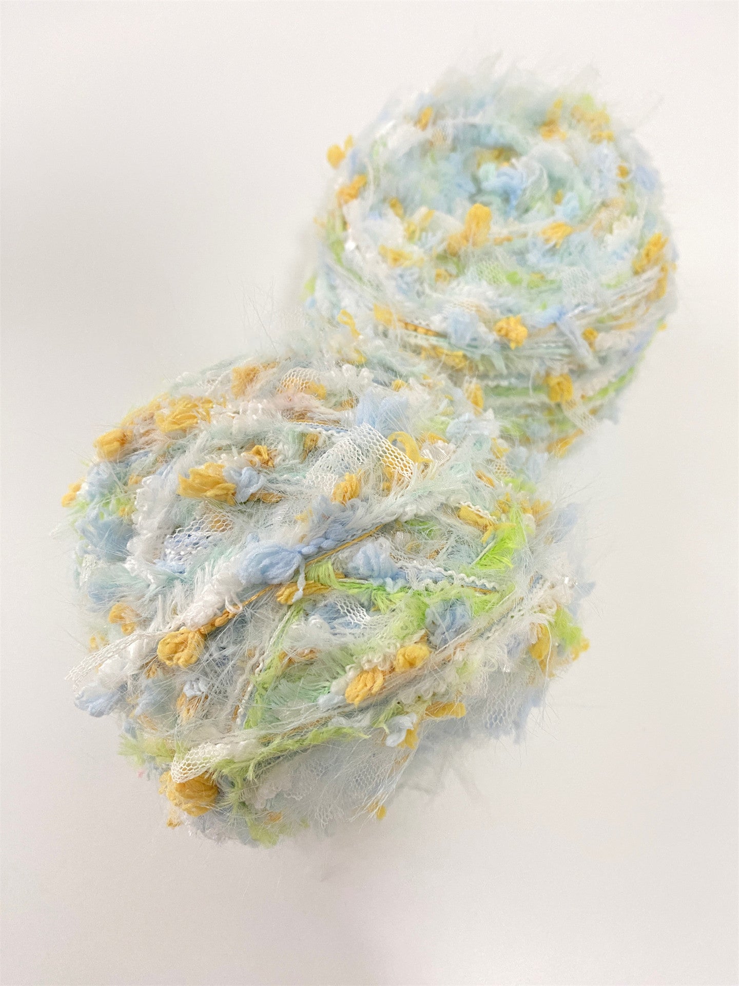 Daisy Chain yarn with white yellow blue and green pastel colors