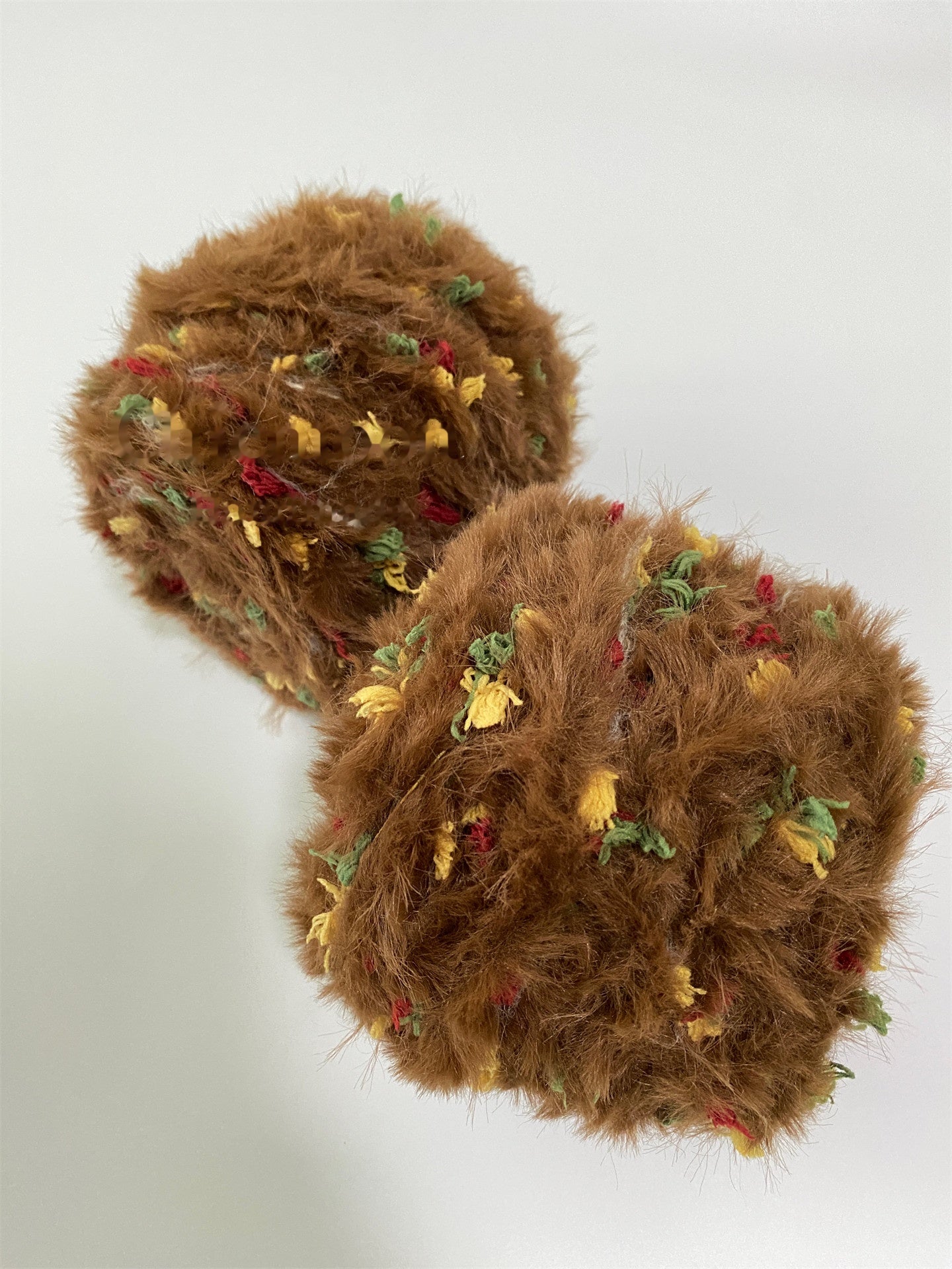 Ginger Cookie fancy yarn beside knitting needles