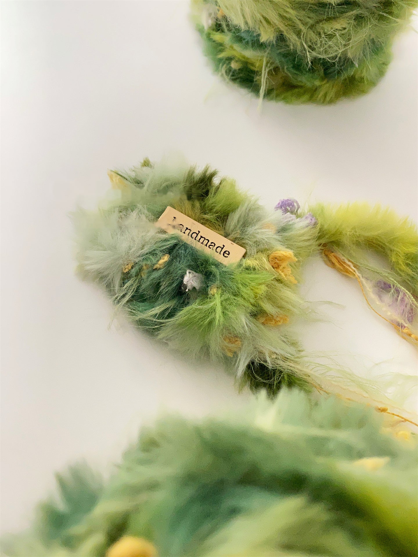 Wild Meadow fancy yarn beside wildflowers