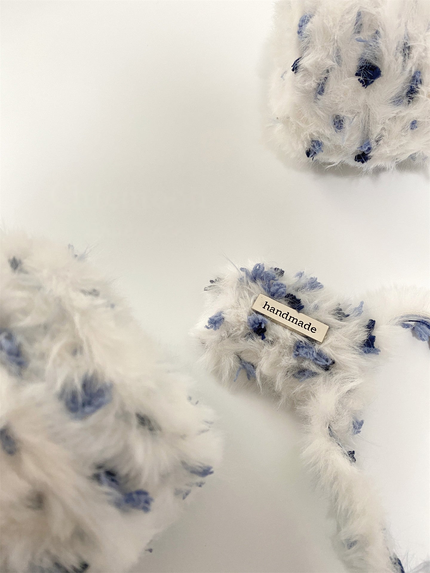 Winter Berry fancy yarn beside handmade accessories