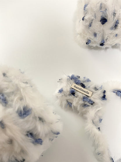 Winter Berry fancy yarn beside handmade accessories